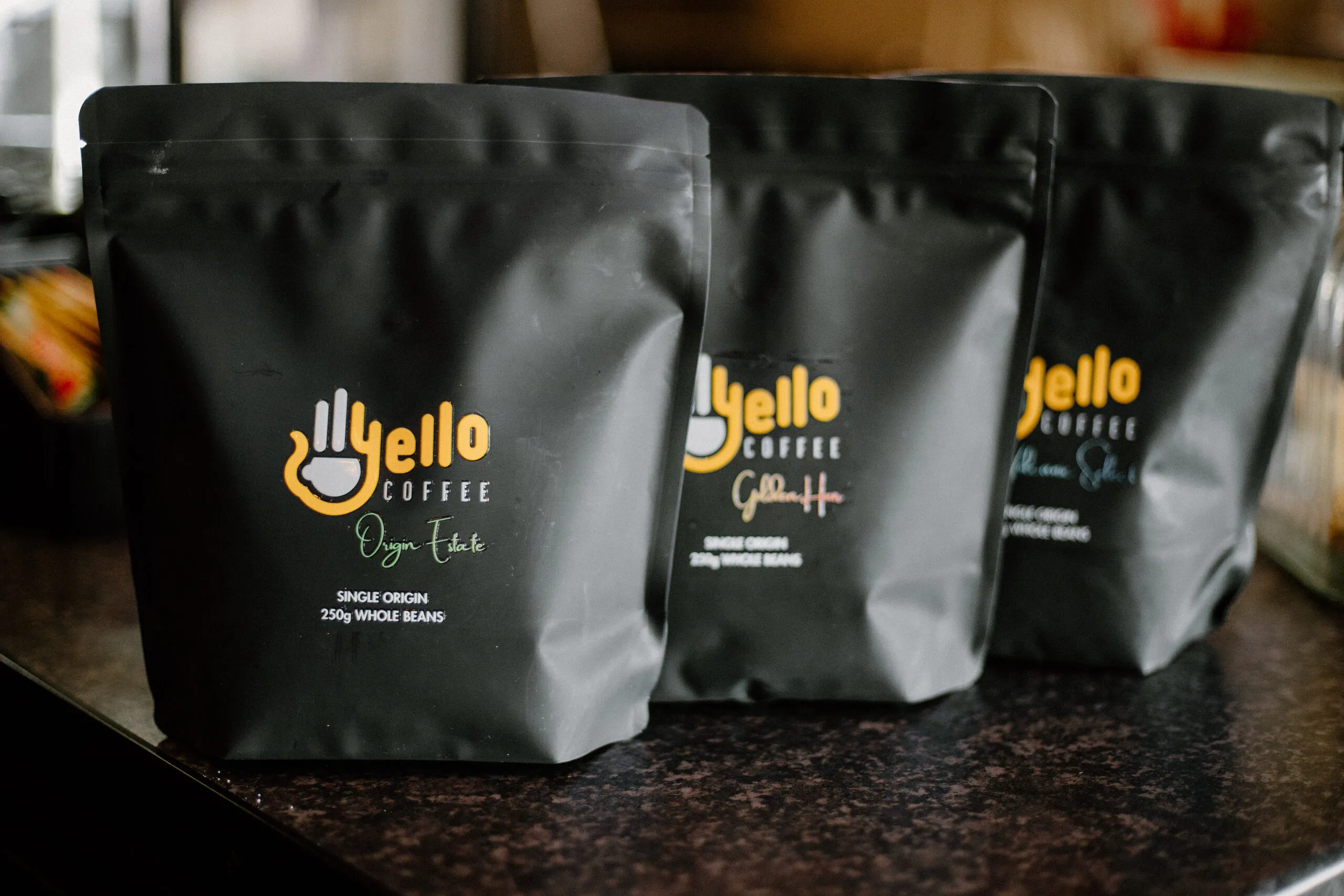 Bags of Yello Coffee beans on a counter
